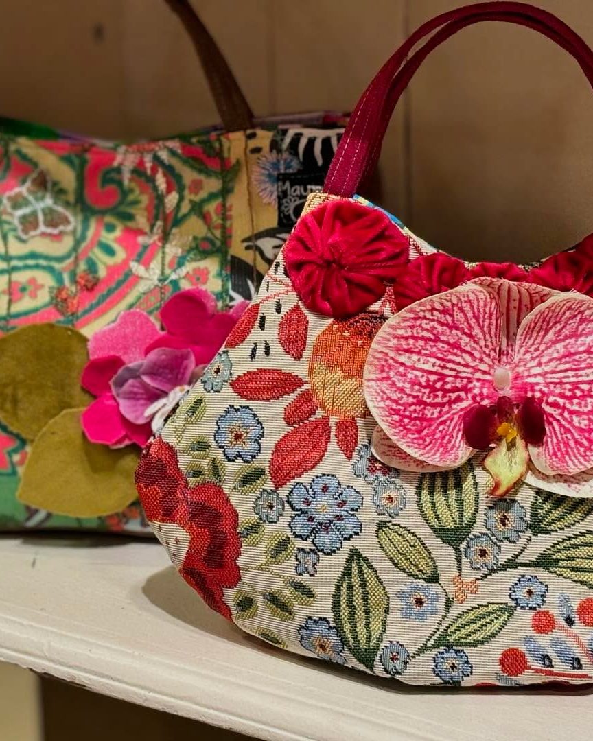 A handmade Mayiu bag with pink floral embroidery