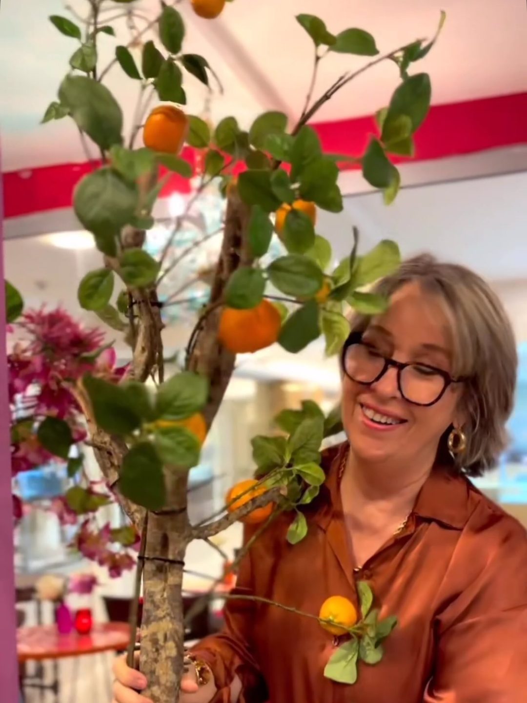A happy moment at Mayiu, holding an orange tree in the store